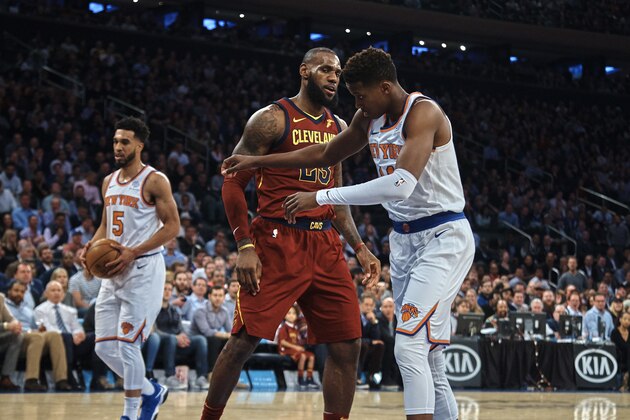 Cleveland Cavaliers' LeBron James, center, discusses with New York Knicks' Frank Ntilikina, right, during the first half of a NBA basketball game at Madison Square Garden in New York, Monday, Nov. 13, 2017. (AP Photo/Andres Kudacki)