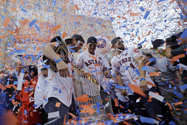 Houston Astros players, from left, Josh Reddick, Carlos Correa (1) and George Springer (4) celebrate during a rally honoring the World Series baseball champions Friday, Nov. 3, 2017, in Houston. (AP Photo/David J. Phillip)