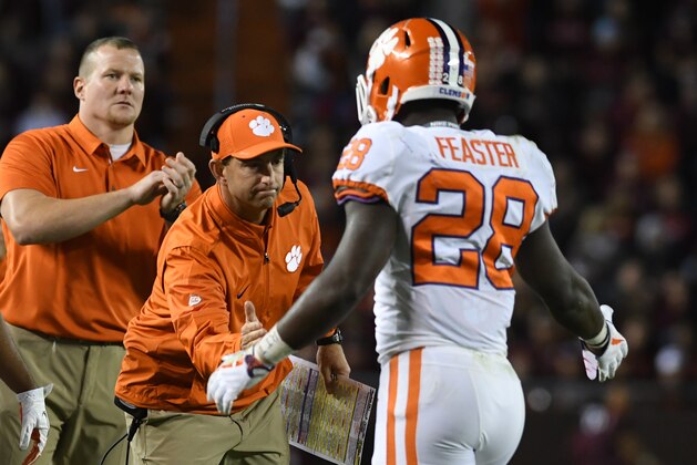 BLACKSBURG, VA - SEPTEMBER 30:  Head coach Dabo Swinney of the Clemson Tigers congratulates Tavien Feaster #28 after a touchdown during the third quarter against the Virginia Tech Hokies at Lane Stadium on September 30, 2017 in Blacksburg, Virginia.  (Photo by Michael Shroyer/Getty Images)
