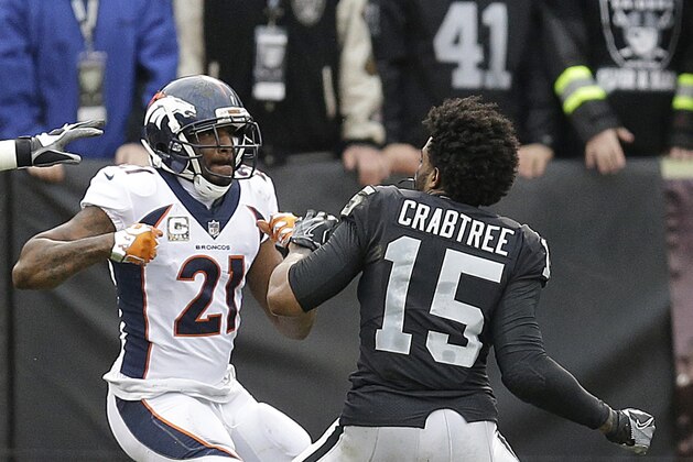 Denver Broncos cornerback Aqib Talib (21) fights Oakland Raiders wide receiver Michael Crabtree (15) during the first half of an NFL football game in Oakland, Calif., Sunday, Nov. 26, 2017. (AP Photo/Ben Margot)