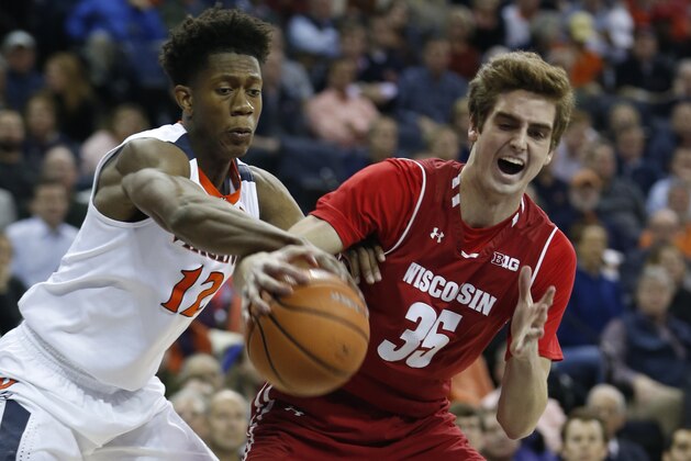 Wisconsin forward Nate Reuvers (35) and Virginia guard De'Andre Hunter (12) fight for a rebound during the first half of an NCAA college basketball game in Charlottesville, Va., Monday, Nov. 27, 2017. (AP Photo/Steve Helber)