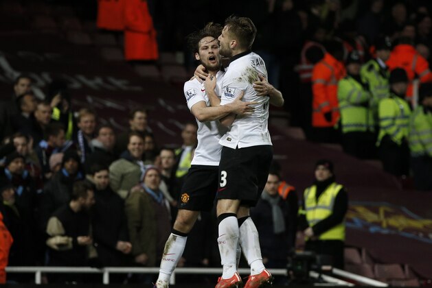 Manchester United's Dutch midfielder Daley Blind (L) celebrates scoring his goal with Manchester United's English defender Luke Shaw (R) during the English Premier League football match between West Ham United and Manchester United at the Boleyn Ground, Upton Park, in east London, on February 8, 2015. The game ended 1-1. AFP PHOTO / ADRIAN DENNIS

== RESTRICTED TO EDITORIAL USE. NO USE WITH UNAUTHORIZED AUDIO, VIDEO, DATA, FIXTURE LISTS, CLUB/LEAGUE LOGOS OR LIVE SERVICES. ONLINE IN-MATCH USE LIMITED TO 45 IMAGES, NO VIDEO EMULATION. NO USE IN BETTING, GAMES OR SINGLE CLUB/LEAGUE/PLAYER PUBLICATIONS. ==        (Photo credit should read ADRIAN DENNIS/AFP/Getty Images)