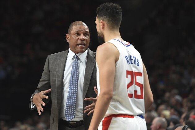 LA Clippers head coach Doc Rivers, left, speaks with Los Angeles Clippers guard Austin Rivers during the first quarter of an NBA basketball game against the Portland Trail Blazers in Portland, Ore., Thursday, Oct. 26, 2017. (AP Photo/Steve Dykes)