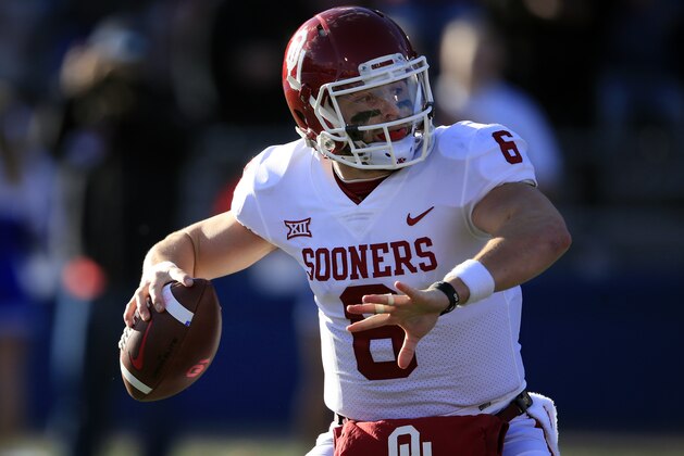 This photo taken Nov. 18, 2017, shows Oklahoma quarterback Baker Mayfield (6) during the first half of an NCAA college football game against Kansas in Lawrence, Kan. While the Sooners have already clinched a spot in the Big 12 championship game, they need to beat West Virginia to stay in the top four of the College Football Playoff rankings. (AP Photo/Orlin Wagner)