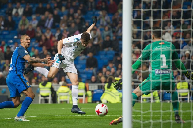 MADRID, SPAIN - NOVEMBER 28: Borja Mayoral of Real Madrid CF beats Pol of Fuenlabrada to score his team's opening goal during the Copa del Rey, Round of 32, Second Leg match between Real Madrid and Fuenlabrada at Estadio Santiago Bernabeu on November 28, 2017 in Madrid, Spain. (Photo by Denis Doyle/Getty Images)