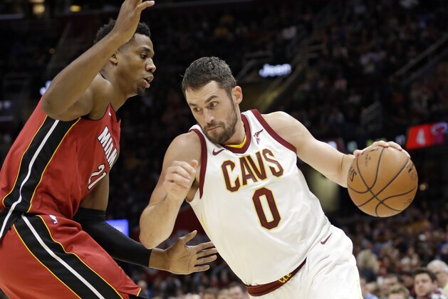 Cleveland Cavaliers' Kevin Love (0) drives against Miami Heat's Hassan Whiteside (21) in the first half of an NBA basketball game, Tuesday, Nov. 28, 2017, in Cleveland. (AP Photo/Tony Dejak)