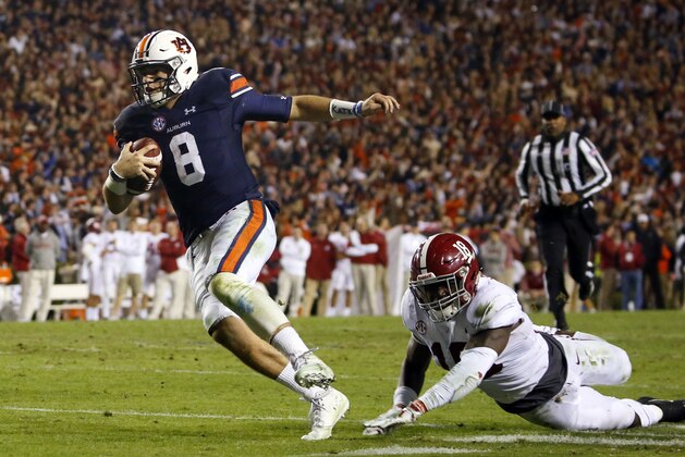 Auburn quarterback Jarrett Stidham (8) gets past Alabama linebacker Dylan Moses (18) to carry the ball in for a touchdown during the second half of the Iron Bowl NCAA college football game, Saturday, Nov. 25, 2017, in Auburn, Ala. (AP Photo/Butch Dill)