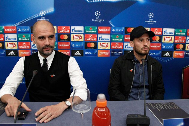 Manchester City's Spanish coach Pep Guardiola (L) and Manchester City's Spanish midfielder David Silva give a press conference on the eve of the UEFA Champions League football match Napoli vs Manchester City, on October 31, 2017 in Naples. / AFP PHOTO / Carlo Hermann        (Photo credit should read CARLO HERMANN/AFP/Getty Images)