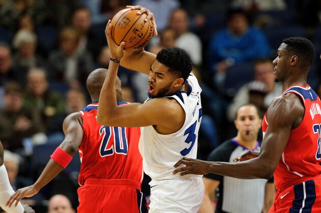 MINNEAPOLIS, MN - NOVEMBER 28: Karl-Anthony Towns #32 of the Minnesota Timberwolves has the ball against Jodie Meeks #20 and Ian Mahinmi #28 of the Washington Wizardsdg= on November 28, 2017 at the Target Center in Minneapolis, Minnesota. NOTE TO USER: User expressly acknowledges and agrees that, by downloading and or using this Photograph, user is consenting to the terms and conditions of the Getty Images License Agreement. (Photo by Hannah Foslien/Getty Images)