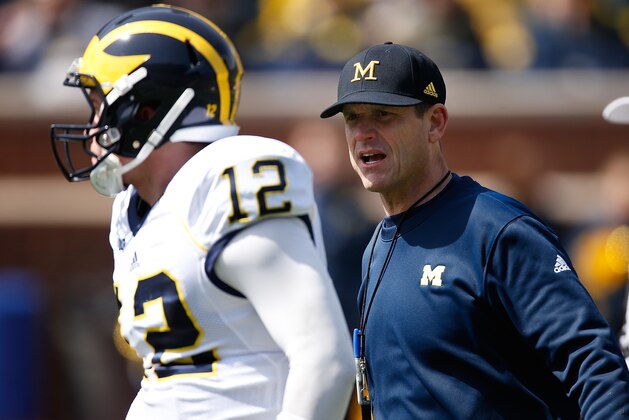 ANN ARBOR, MI - APRIL 04: Head coach Jim Harbaugh of the Michigan Wolverines talks to Alex Malzone #12 during the Michigan Football Spring Game on April 4, 2015 at Michigan Stadium in Ann Arbor, Michigan.  (Photo by Gregory Shamus/Getty Images)