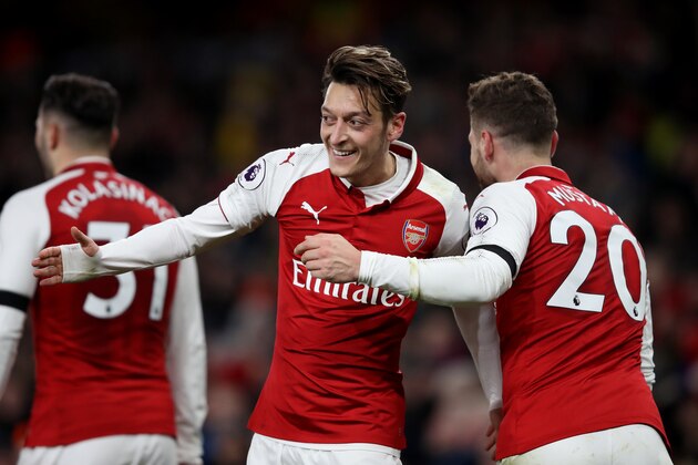 LONDON, ENGLAND - NOVEMBER 29: Mesut Ozil of Arsenal celebrates after scoring his sides fourth goal with Shkodran Mustafi of Arsenal during the Premier League match between Arsenal and Huddersfield Town at Emirates Stadium on November 29, 2017 in London, England.  (Photo by Julian Finney/Getty Images)