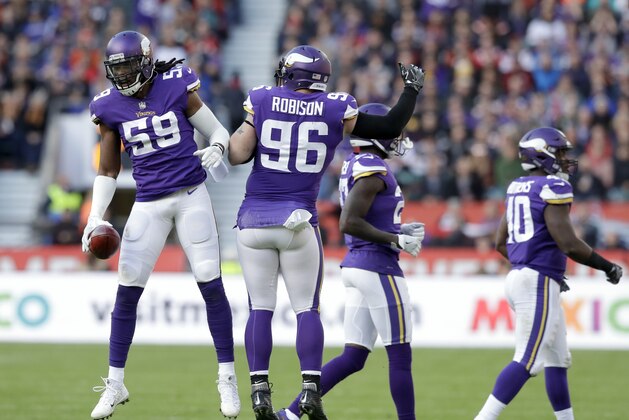 Minnesota Vikings linebacker Emmanuel Lamur (59) and defensive end Brian Robison (96) celebrate after forcing a turnover during the first quarter of an NFL football game against the Cleveland Browns at Twickenham Stadium in London, Sunday Oct. 29, 2017. (AP Photo/Matt Dunham)
