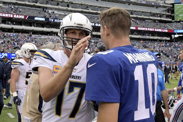 Los Angeles Chargers quarterback Philip Rivers, left, and New York Giants quarterback Eli Manning converse after an NFL football game, Sunday, Oct. 8, 2017, in East Rutherford, N.J. The Chargers won 27-22. (AP Photo/Bill Kostroun)