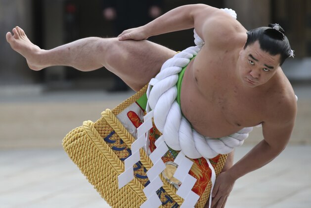 Sumo grand champion Harumafuji of Mongolia performs his ring entry forms at the Meiji Shrine in Tokyo, Friday, Jan. 6, 2017. The Shinto ritual is part of the annual New Year's celebrations at the shrine. (AP Photo/Koji Sasahara)
