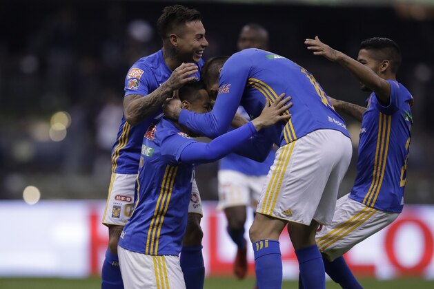 Tigres' Anselmo Juninho celebrates on his knees with teammate Andre Pierre Gignac, second from right, and Silvio Romero, left, after scoring a penalty kick against America during a Mexico soccer league semifinal first leg match at Estadio Azteca in Mexico City, Wednesday, Nov. 29, 2017. (AP Photo/Rebecca Blackwell)