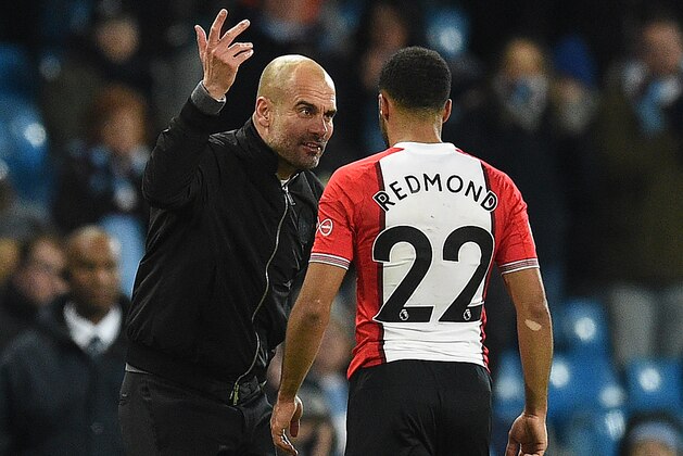 Manchester City's Spanish manager Pep Guardiola reacts as he talks with Southampton's English midfielder Nathan Redmond following the English Premier League football match between Manchester City and Southampton at the Etihad Stadium in Manchester, north west England, on November 29, 2017.
Manchester City won the match 2-1. / AFP PHOTO / Oli SCARFF / RESTRICTED TO EDITORIAL USE. No use with unauthorized audio, video, data, fixture lists, club/league logos or 'live' services. Online in-match use limited to 75 images, no video emulation. No use in betting, games or single club/league/player publications.  /         (Photo credit should read OLI SCARFF/AFP/Getty Images)