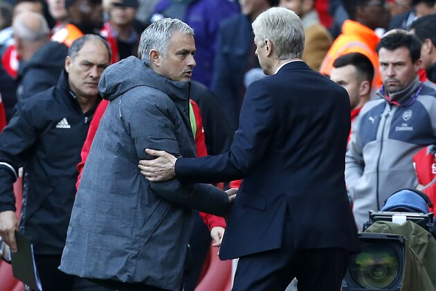 Arsenal's French manager Arsene Wenger shakes hands with Manchester United's Portuguese manager Jose Mourinho (2nd L) after the English Premier League football match between Arsenal and Manchester United at the Emirates Stadium in London on May 7, 2017. 
Arsenal won the game 2-0. / AFP PHOTO / IKIMAGES / Ian KINGTON / RESTRICTED TO EDITORIAL USE. No use with unauthorized audio, video, data, fixture lists, club/league logos or 'live' services. Online in-match use limited to 45 images, no video emulation. No use in betting, games or single club/league/player publications.  /         (Photo credit should read IAN KINGTON/AFP/Getty Images)