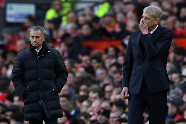 Manchester United's Portuguese manager Jose Mourinho (L) and Arsenal's French manager Arsene Wenger react as they watch their players from the touchline during the English Premier League football match between Manchester United and Arsenal at Old Trafford in Manchester, north west England, on November 19, 2016. / AFP / Paul ELLIS / RESTRICTED TO EDITORIAL USE. No use with unauthorized audio, video, data, fixture lists, club/league logos or 'live' services. Online in-match use limited to 75 images, no video emulation. No use in betting, games or single club/league/player publications.  /         (Photo credit should read PAUL ELLIS/AFP/Getty Images)