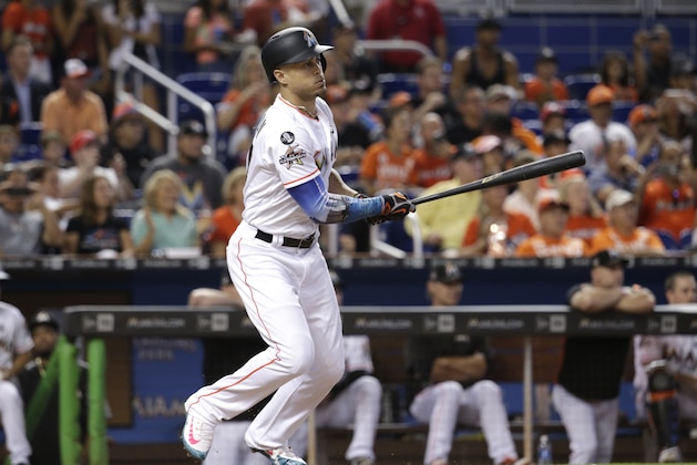 Miami Marlins' Giancarlo Stanton hits a single during the third inning of a baseball game against the Atlanta Braves, Sunday, Oct. 1, 2017, in Miami. (AP Photo/Lynne Sladky)