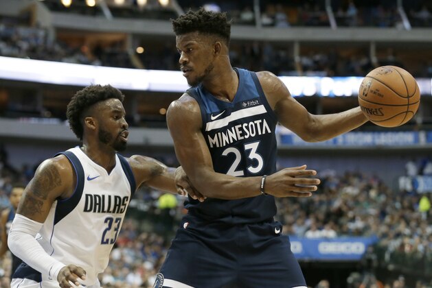 Dallas Mavericks' Wesley Matthews, left, defends as Minnesota Timberwolves' Jimmy Butler, right, handles the ball during an NBA basketball game, Friday, Nov. 17, 2017, in Dallas. (AP Photo/Tony Gutierrez)