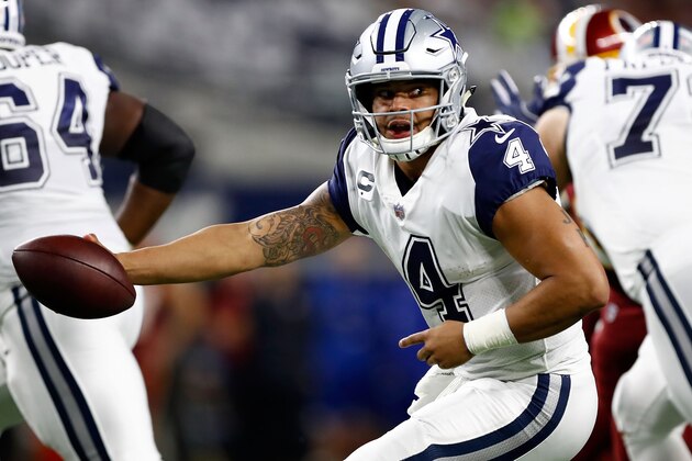 ARLINGTON, TX - NOVEMBER 30:  Dak Prescott #4 of the Dallas Cowboys reaches to make a handoff in the first half of a football game against the Washington Redskins at AT&T Stadium on November 30, 2017 in Arlington, Texas.  (Photo by Wesley Hitt/Getty Images)