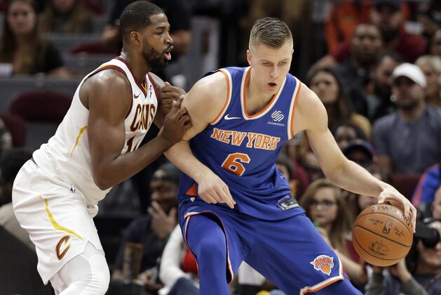 New York Knicks' Kristaps Porzingis (6), from Latvia, drives against Cleveland Cavaliers' Tristan Thompson (13) in the first half of an NBA basketball game, Sunday, Oct. 29, 2017, in Cleveland. (AP Photo/Tony Dejak)