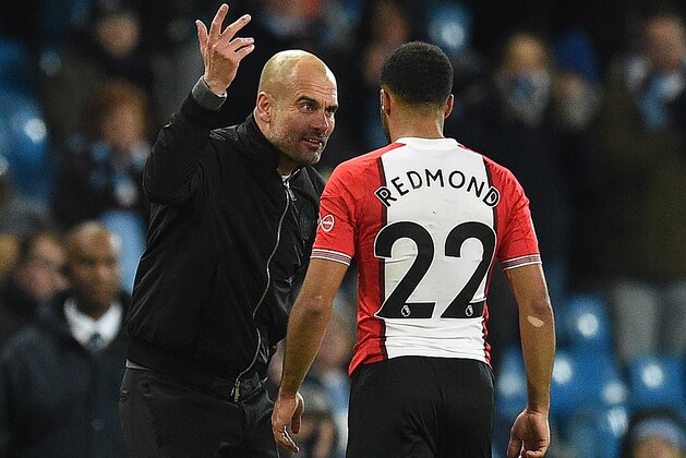 Manchester City's Spanish manager Pep Guardiola reacts as he talks with Southampton's English midfielder Nathan Redmond following the English Premier League football match between Manchester City and Southampton at the Etihad Stadium in Manchester, north west England, on November 29, 2017.
Manchester City won the match 2-1. / AFP PHOTO / Oli SCARFF / RESTRICTED TO EDITORIAL USE. No use with unauthorized audio, video, data, fixture lists, club/league logos or 'live' services. Online in-match use limited to 75 images, no video emulation. No use in betting, games or single club/league/player publications.  /         (Photo credit should read OLI SCARFF/AFP/Getty Images)