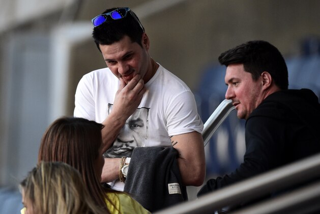 Brothers of Barcelona's player Lionel Messi, Rodrigo (L) and Matias, attend a training session of Barcelona at the Parc des Princes stadium in Paris on April 14, 2015, on the eve of the UEFA Champions League quarter final first leg football match Paris against Barcelona.  AFP PHOTO / FRANCK FIFE        (Photo credit should read FRANCK FIFE/AFP/Getty Images)