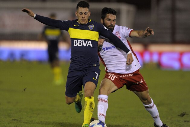 Boca Juniors' forward Cristian Pavon (L) vies for the ball with Huracan's defender Nicolas Romat during their Argentina First Division football match at Tomas Duco stadium in Buenos Aires, on May 27, 2017. / AFP PHOTO / ALEJANDRO PAGNI        (Photo credit should read ALEJANDRO PAGNI/AFP/Getty Images)