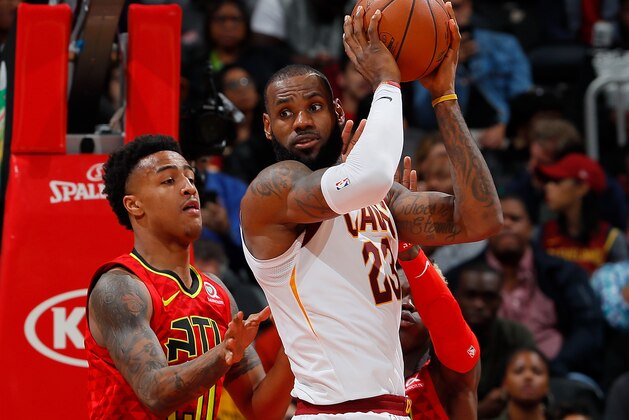 ATLANTA, GA - NOVEMBER 30:  LeBron James #23 of the Cleveland Cavaliers looks to pass as he drives against John Collins #20 and Dennis Schroder #17 of the Atlanta Hawks at Philips Arena on November 30, 2017 in Atlanta, Georgia.  NOTE TO USER: User expressly acknowledges and agrees that, by downloading and or using this photograph, User is consenting to the terms and conditions of the Getty Images License Agreement.  (Photo by Kevin C. Cox/Getty Images)