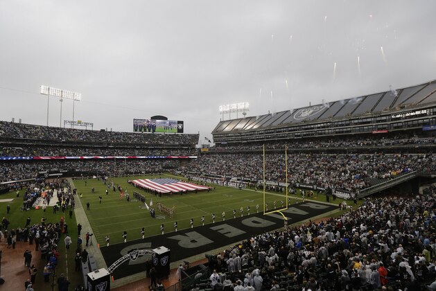 A flag is presented on the field at Oakland Alameda County Coliseum during the national anthem before an NFL football game between the Oakland Raiders and the Denver Broncos in Oakland, Calif., Sunday, Nov. 26, 2017. (AP Photo/Jeff Chiu)