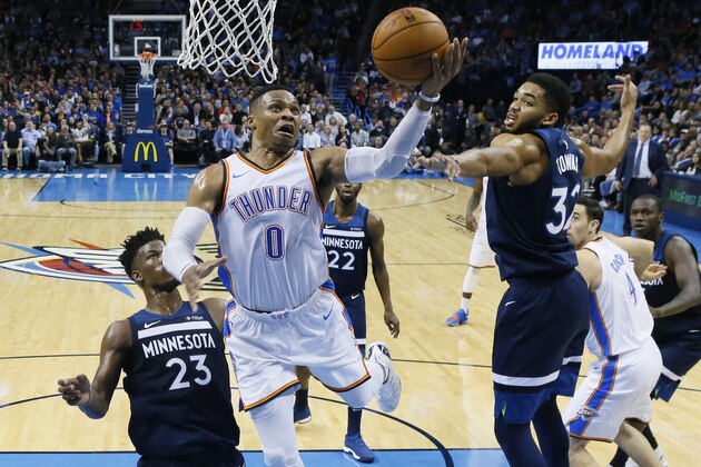 Oklahoma City Thunder guard Russell Westbrook (0) shoots between Minnesota Timberwolves guard Jimmy Butler (23) and center Karl-Anthony Towns during the second quarter of an NBA basketball game in Oklahoma City, Friday, Dec. 1, 2017. (AP Photo/Sue Ogrocki)