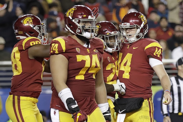 Southern California running back Ronald Jones II, second from right, celebrates with quarterback Sam Darnold (14) and teammates after scoring a touchdown against Stanford during the second half of the Pac-12 Conference championship NCAA college football game in Santa Clara, Calif., Friday, Dec. 1, 2017. (AP Photo/Marcio Jose Sanchez)