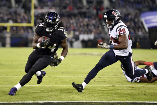 Baltimore Ravens running back Alex Collins, left, rushes past Houston Texans free safety Andre Hal for a touchdown in the first half of an NFL football game, Monday, Nov. 27, 2017, in Baltimore. (AP Photo/Gail Burton)