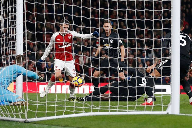 Manchester United's Belgian striker Romelu Lukaku (2R) clears the ball from the path of Arsenal's Swiss midfielder Granit Xhaka (2L) during the English Premier League football match between Arsenal and Manchester United at the Emirates Stadium in London on December 2, 2017.  / AFP PHOTO / IKIMAGES / Ian KINGTON / RESTRICTED TO EDITORIAL USE. No use with unauthorized audio, video, data, fixture lists, club/league logos or 'live' services. Online in-match use limited to 45 images, no video emulation. No use in betting, games or single club/league/player publications.        (Photo credit should read IAN KINGTON/AFP/Getty Images)
