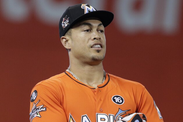 Miami Marlins right fielder Giancarlo Stanton stands on the field before a baseball game against the Philadelphia Phillies, Sunday, Sept. 3, 2017, in Miami. (AP Photo/Lynne Sladky)