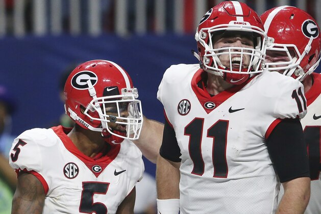 Georgia wide receiver Terry Godwin (5) celebrates his touchdown catch with Georgia quarterback Jake Fromm (11) against Auburn during the second half of the Southeastern Conference championship NCAA college football game, Saturday, Dec. 2, 2017, in Atlanta. (AP Photo/John Bazemore)