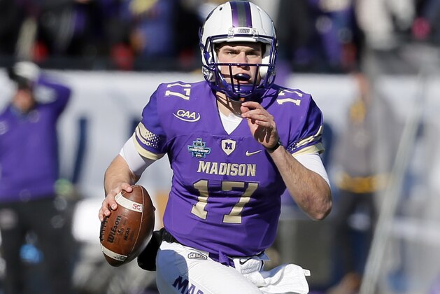 James Madison quarterback Bryan Schor (17) scrambles out of the pocket before throwing a pass in the first half of the FCS championship NCAA college football game against Youngstown State on Saturday, Jan. 7, 2017, in Frisco, Texas. (AP Photo/Tony Gutierrez)