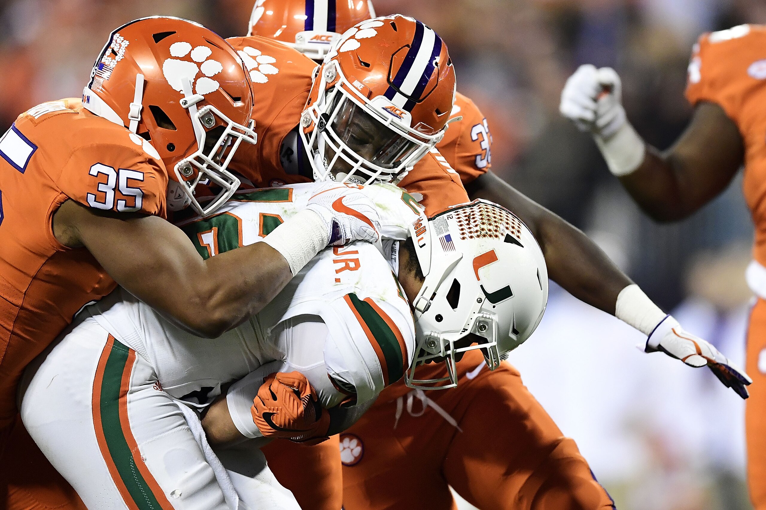 CHARLOTTE, NC - DECEMBER 02:  Justin Foster #35 of the Clemson Tigers leads a tackle of Malik Rosier #12 of the Miami Hurricanes during the ACC Football Championship at Bank of America Stadium on December 2, 2017 in Charlotte, North Carolina.  (Photo by Mike Comer/Getty Images)