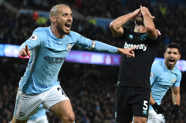 West Ham United's Argentinian defender Pablo Zabaleta (C) reacts as Manchester City's Spanish midfielder David Silva (L) celebrates scoring their second goal during the English Premier League football match between Manchester City and West Ham United at the Etihad Stadium in Manchester, north west England, on December 3, 2017. / AFP PHOTO / Oli SCARFF / RESTRICTED TO EDITORIAL USE. No use with unauthorized audio, video, data, fixture lists, club/league logos or 'live' services. Online in-match use limited to 75 images, no video emulation. No use in betting, games or single club/league/player publications.  /         (Photo credit should read OLI SCARFF/AFP/Getty Images)