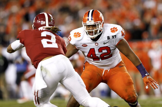 TAMPA, FL - JANUARY 09: Defensiive End Christian Wilkins #42 of the Clemson Tigers attempts to make a tackle against Quarterback Jalen Hurts #2 of the Alabama Cimson Tide during the 2017 College Football Playoff National Championship Game at Raymond James Stadium on January 9, 2017 in Tampa, Florida. The Clemson Tigers defeated The Alabama Crimson Tide 35 to 31. (Photo by Don Juan Moore/Getty Images)