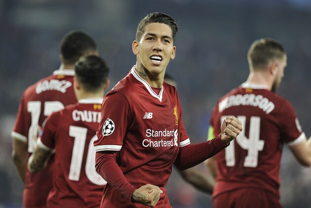 TOPSHOT - Liverpool's Brazilian midfielder Roberto Firmino celebrates after scoring a goal on November 21, 2017 at the Ramon Sanchez Pizjuan stadium in Sevilla during the UEFA Champions League group E football match between Sevilla FC and Liverpool FC. / AFP PHOTO / CRISTINA QUICLER        (Photo credit should read CRISTINA QUICLER/AFP/Getty Images)