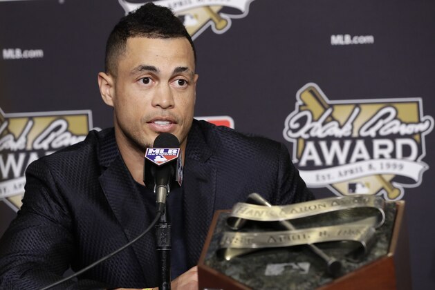 Miami Marlins' Giancarlo Stanton talks after winning the National League Hank Aaron Award at baseball's World Series Wednesday, Oct. 25, 2017, in Los Angeles. (AP Photo/Alex Gallardo)