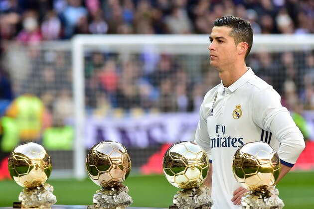 Real Madrid's Portuguese forward Cristiano Ronaldo poses with his four Ballon d'Or France Football trophies before the Spanish league football match Real Madrid CF vs Granada FC at the Santiago Bernabeu stadium in Madrid on January 7, 2017.
Real Madrid won 5-0. / AFP / GERARD JULIEN        (Photo credit should read GERARD JULIEN/AFP/Getty Images)