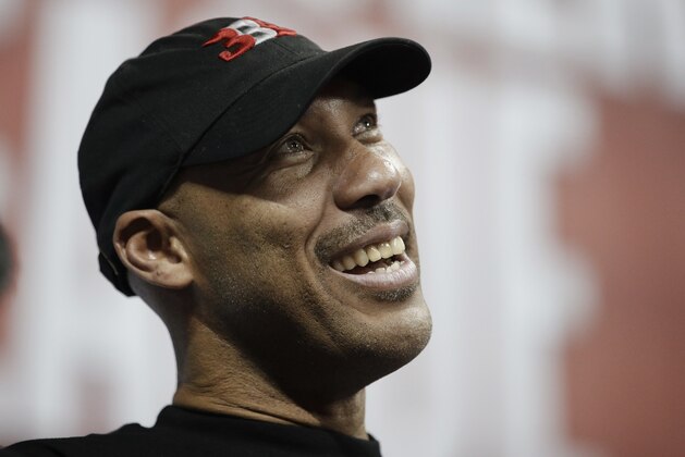 FILE - In this July 7, 2017, file photo, LaVar Ball, father of Los Angeles Lakers' Lonzo Ball and UCLA player LiAngelo Ball, watches the Lakers play the Los Angeles Clippers during an NBA summer league basketball game, in Las Vegas. President Donald Trump tweeted Sunday, Nov. 19, that he should have left three UCLA basketball players, including LiAngelo Ball, accused of shoplifting in China in jail after LaVar Ball minimized Trump’s involvement in winning the players’ release during an interview Saturday, Nov. 18, with ESPN. (AP Photo/John Locher, File)