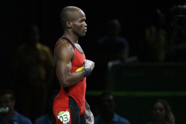Edwin Orlando Mosquera Roa, of Colombia, prepares for a lift in the men's 69kg weightlifting competition at the 2016 Summer Olympics in Rio de Janeiro, Brazil, Tuesday, Aug. 9, 2016. (AP Photo/Mike Groll)