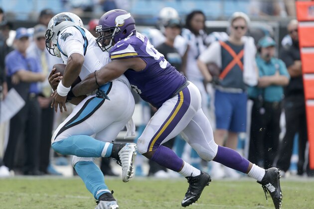 FILE - In this Sept. 18, 2016, file photo, Carolina Panthers' Cam Newton (1) can't get out of a sack by Minnesota Vikings' Everson Griffen (97) during the second half of an NFL football game in Charlotte, N.C.  The Houston Texans and Minnesota Vikings are among the teams with the top records in the NFL winning with defense first and quarterback second. (AP Photo/Bob Leverone, File)