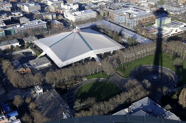 FILE - In this Jan. 29, 2015, file photo, KeyArena, which hosts sports and entertainment events, is seen from the air next to the shadow of the Space Needle in Seattle. Seattle Mayor Ed Murray announced Wednesday, June 7, 2017, that the city will enter into negotiations with the Oak View Group on a proposal for a privately-financed renovation of the city-owned KeyArena. Plans for the remodel would bring the building up to standards that could attract an NHL hockey or NBA basketball team once completed. (AP Photo/Ted S. Warren)