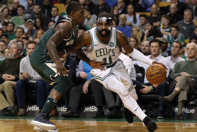Boston Celtics' Kyrie Irving drives on Milwaukee Bucks' Eric Bledsoe during the second quarter of an NBA basketball game in Boston, Monday, Dec. 4, 2017. (AP Photo/Winslow Townson)