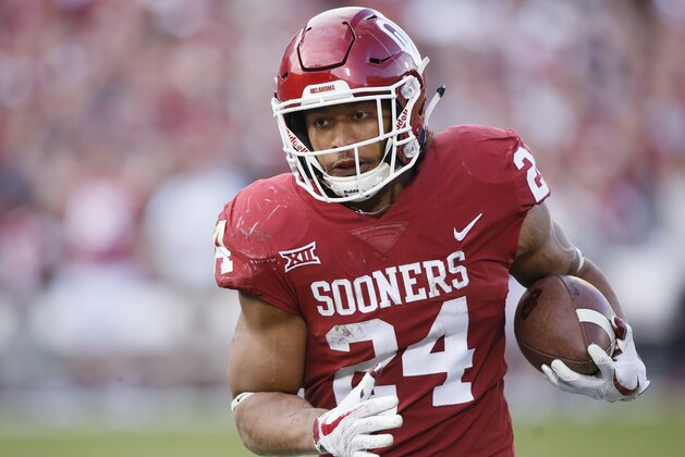 Oklahoma running back Rodney Anderson (24) carries in the second quarter of an NCAA college football game against West Virginia in Norman, Okla., Saturday, Nov. 25, 2017. (AP Photo/Sue Ogrocki)